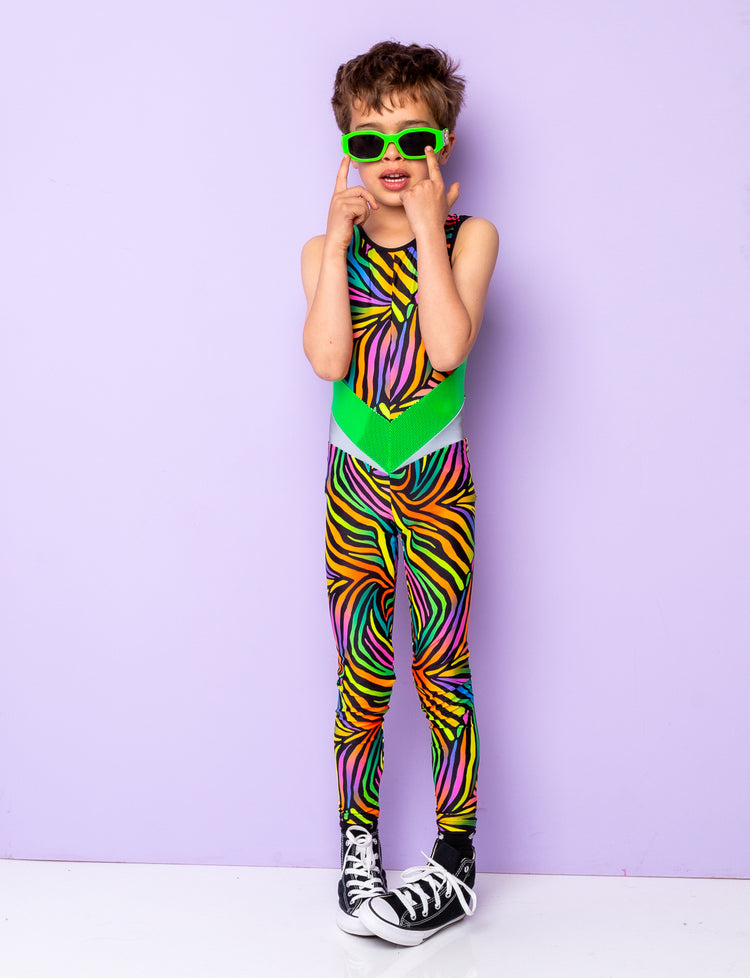 Boy modelling a multi coloured zebra print lycra catsuit and lime green sunglasses.