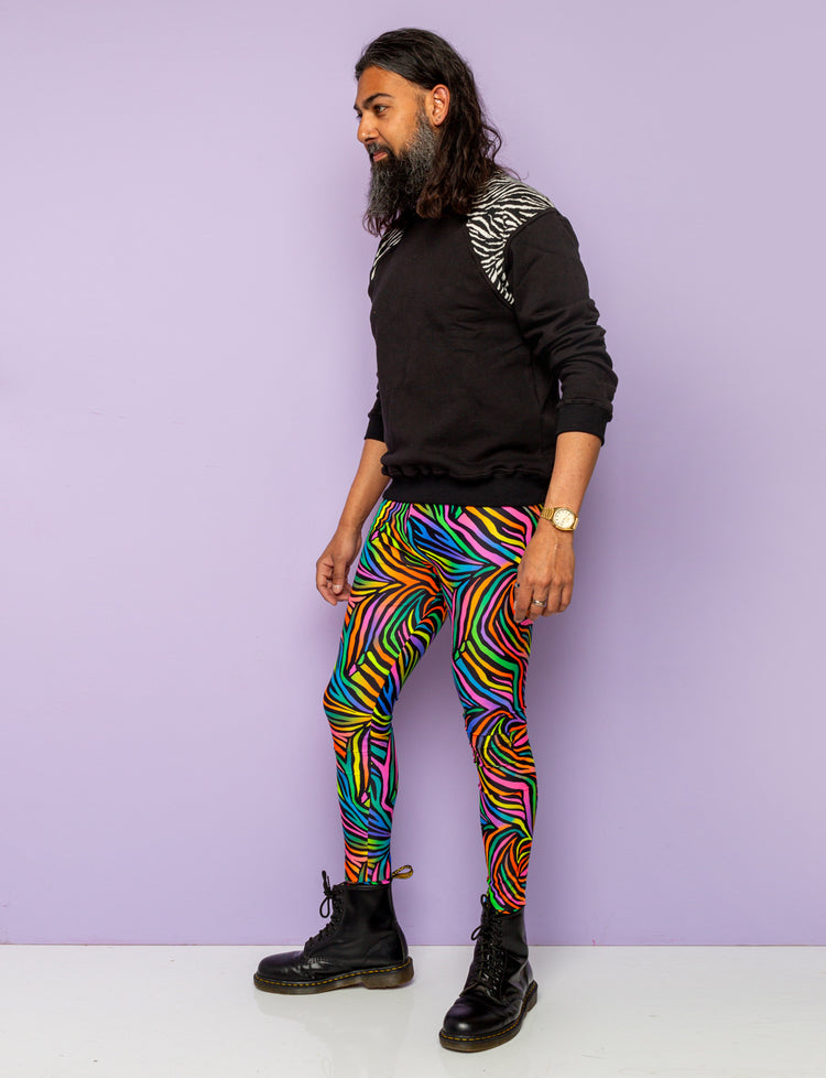 Man modelling rainbow zebra mens leggings and black zebra print sweatshirt.