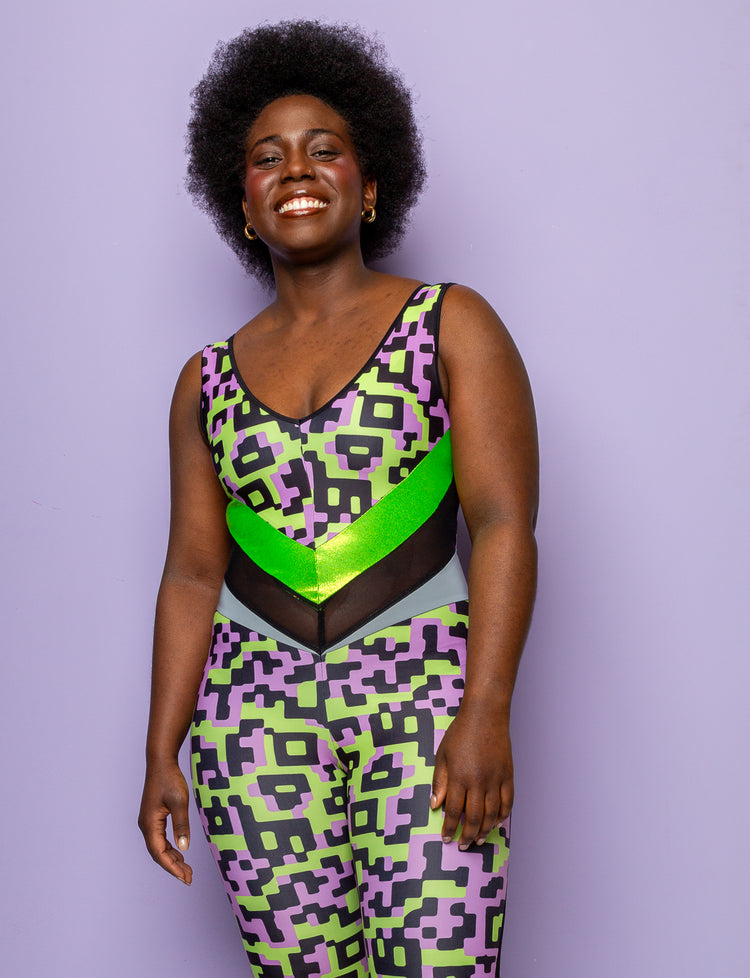 Woman wearing a lilac and lime green patterned lycra catsuit.