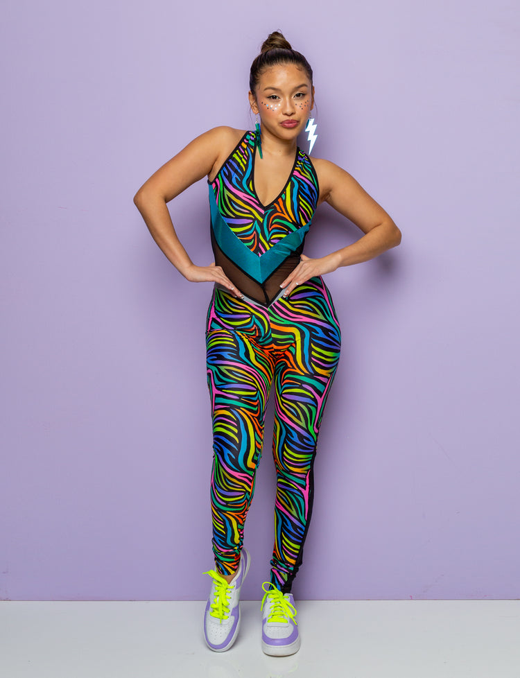 Woman modelling a multi coloured zebra print catsuit.