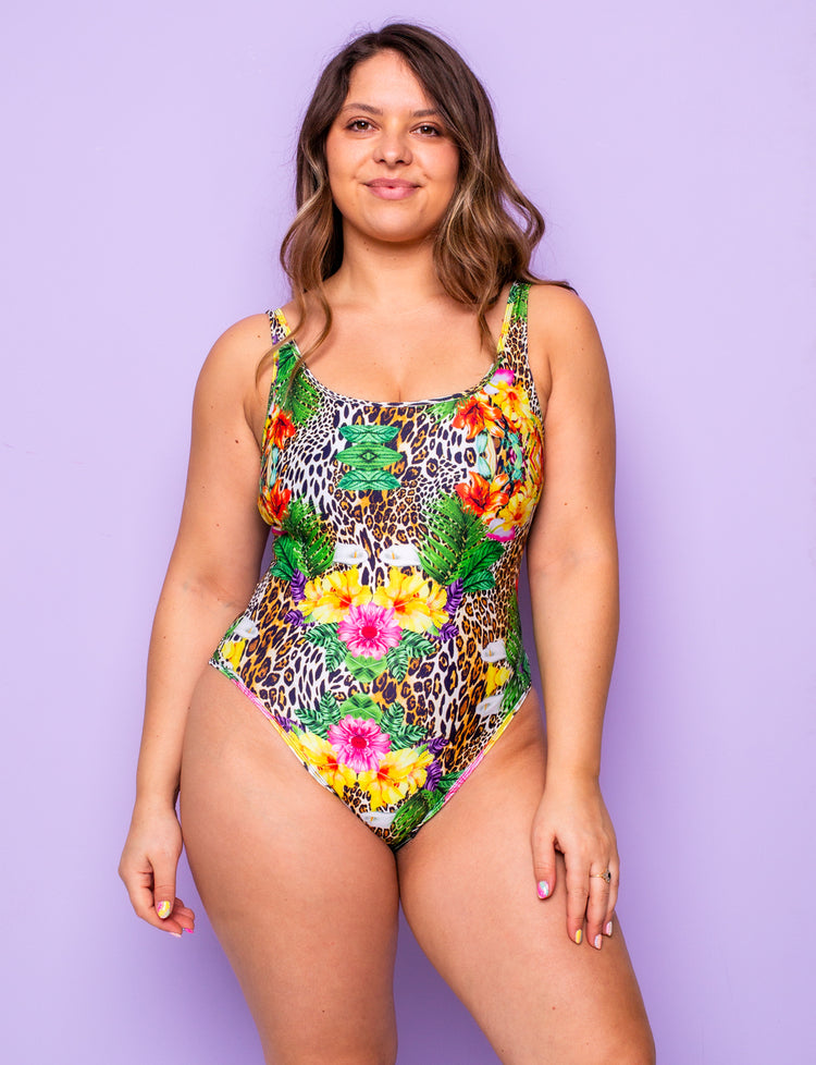 Woman wearing a tropical leopard print lycra bodysuit.