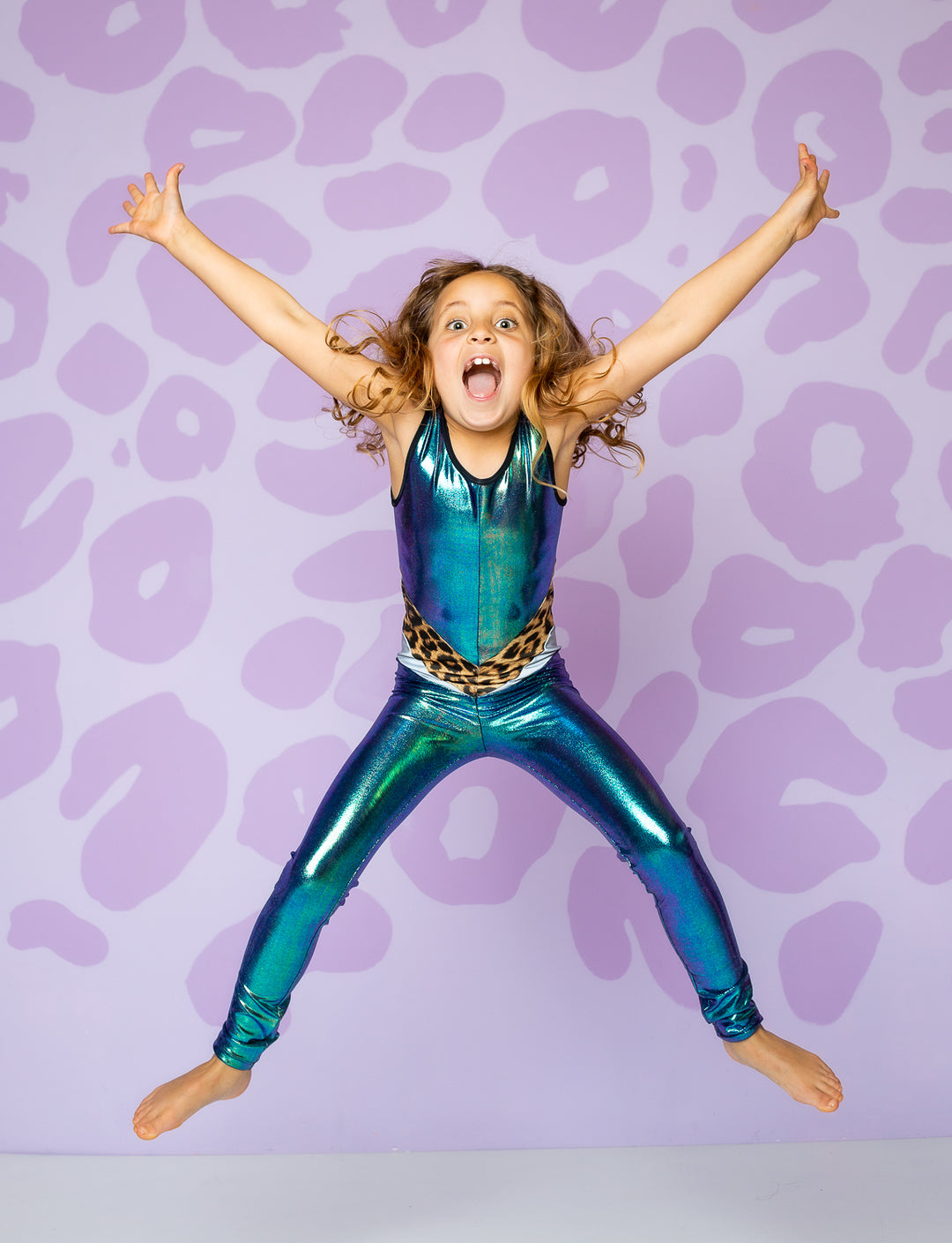 girl wearing catsuit made from shiny green fabric with leopard band on waist