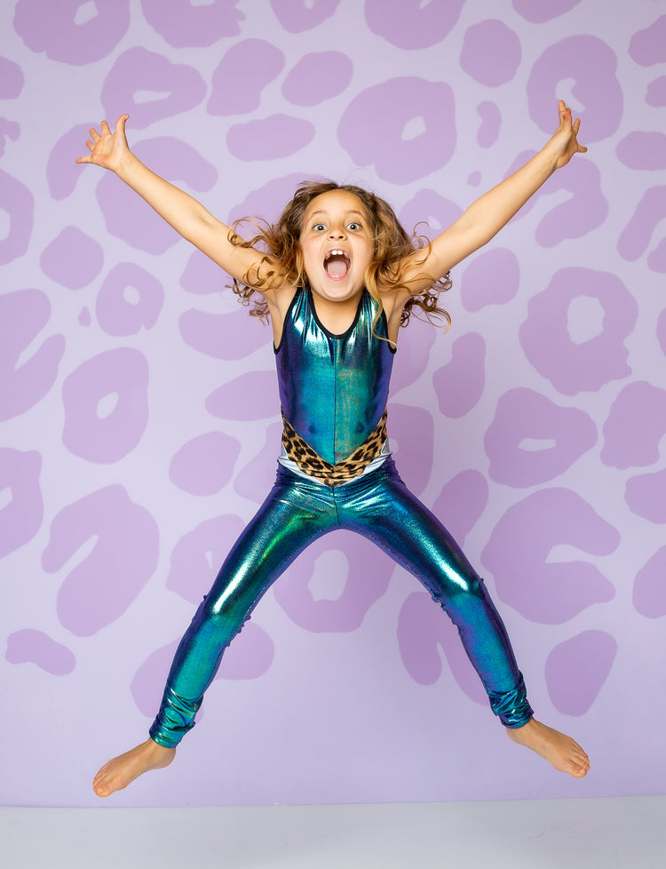girl wearing catsuit made from shiny green fabric with leopard band on waist