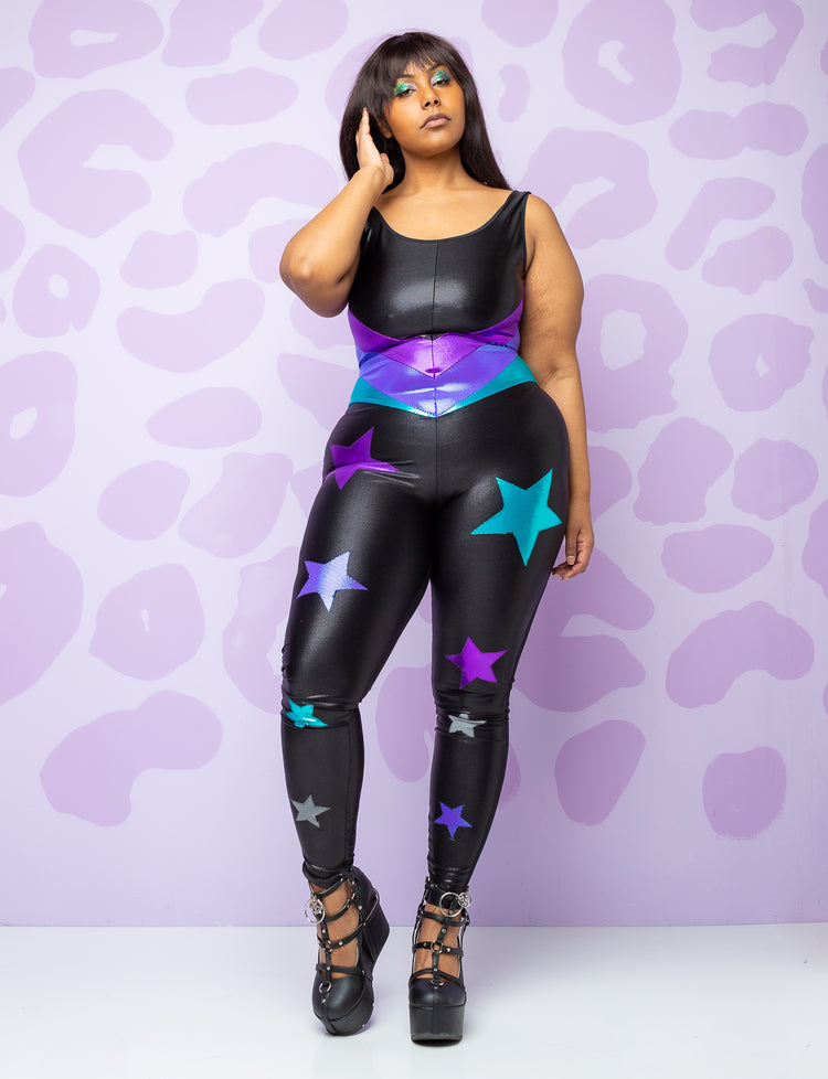 woman wearing black catsuit with purple and turquoise stars on the legs and panels on the body