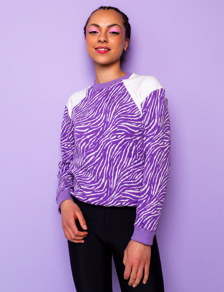 lilac and white zebra print sweatshirt tucked under at hips