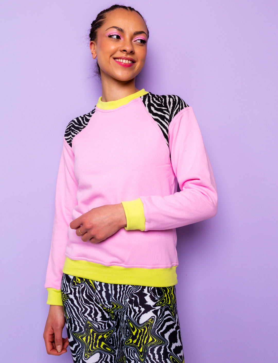 woman wearing a pink sweatshirt with zebra prints shoulders