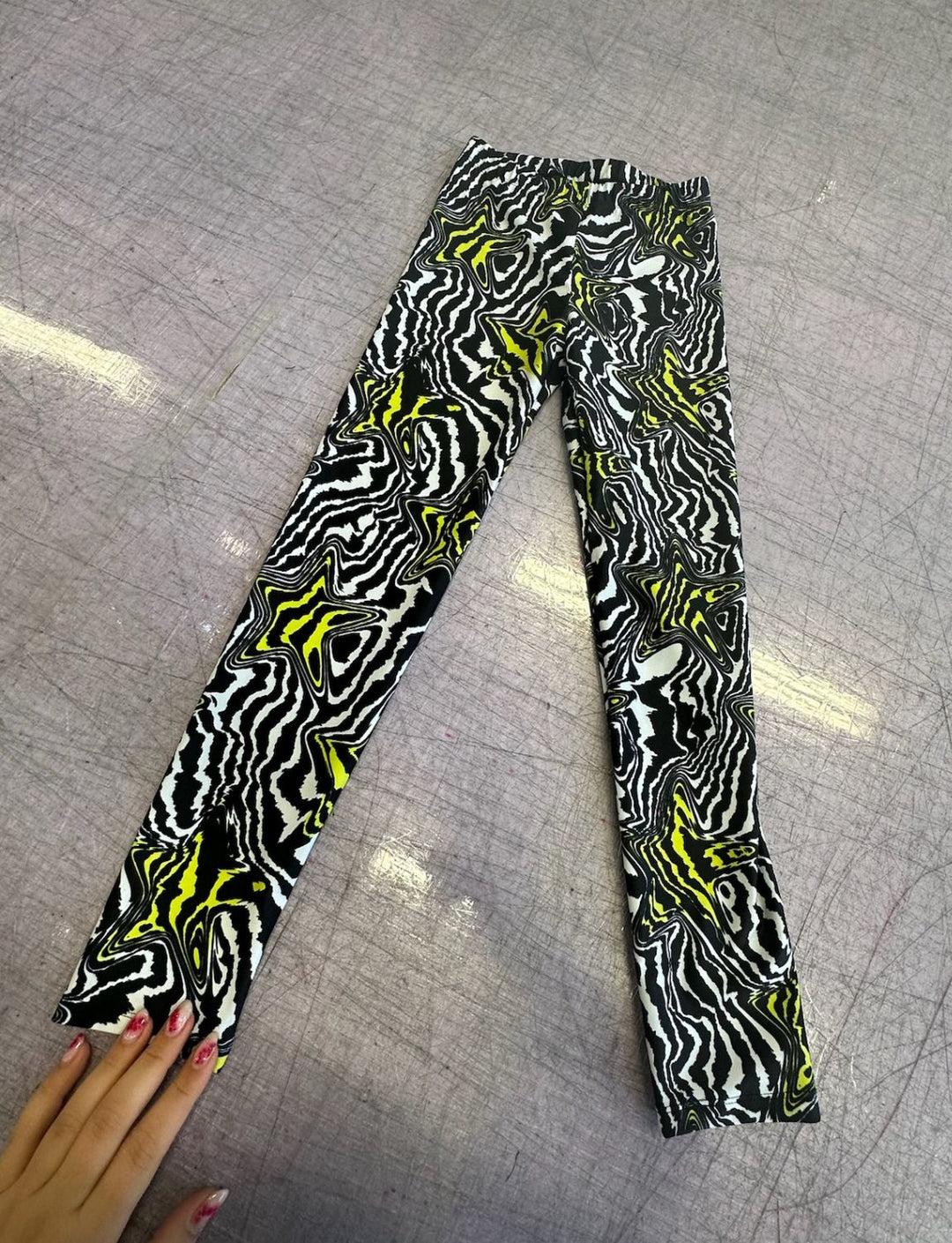 Kids lycra leggings in a black and white swirly pattern with yellow stars.