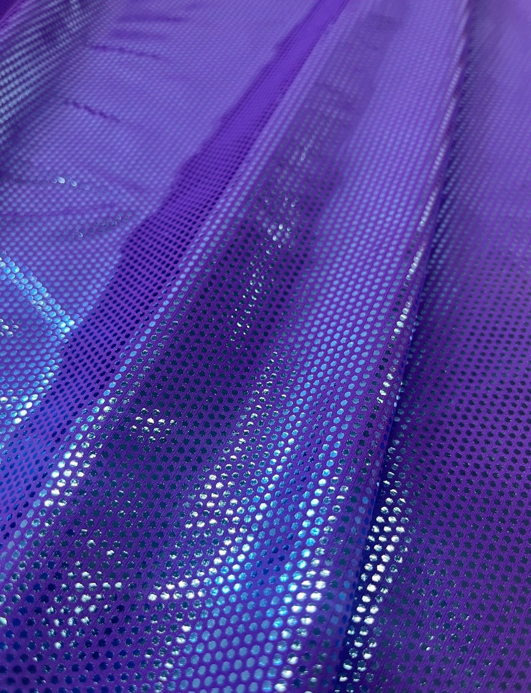 Blue spotted foil fabric on a purple stretch base.