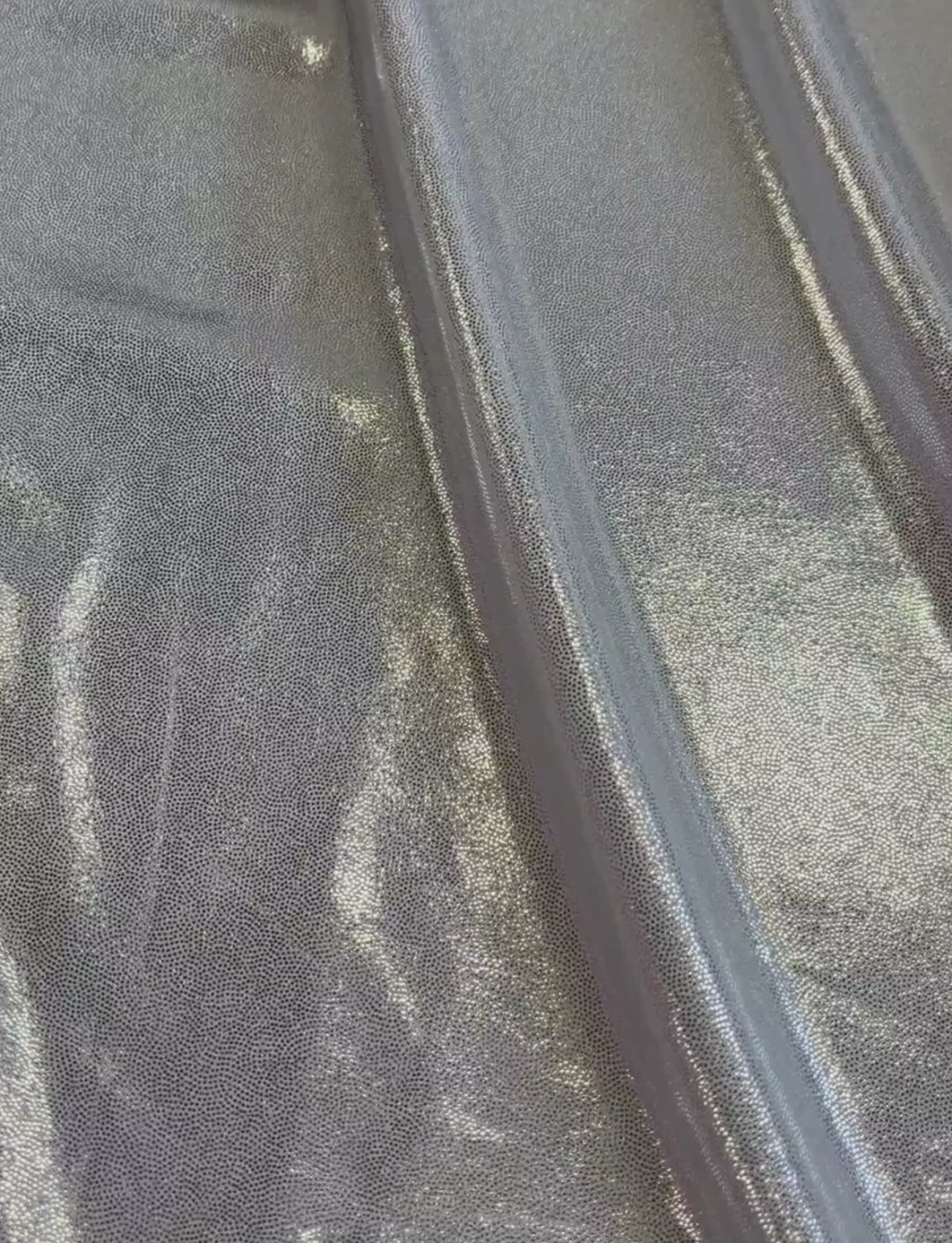 Silver foiled fabric on a white spandex base.