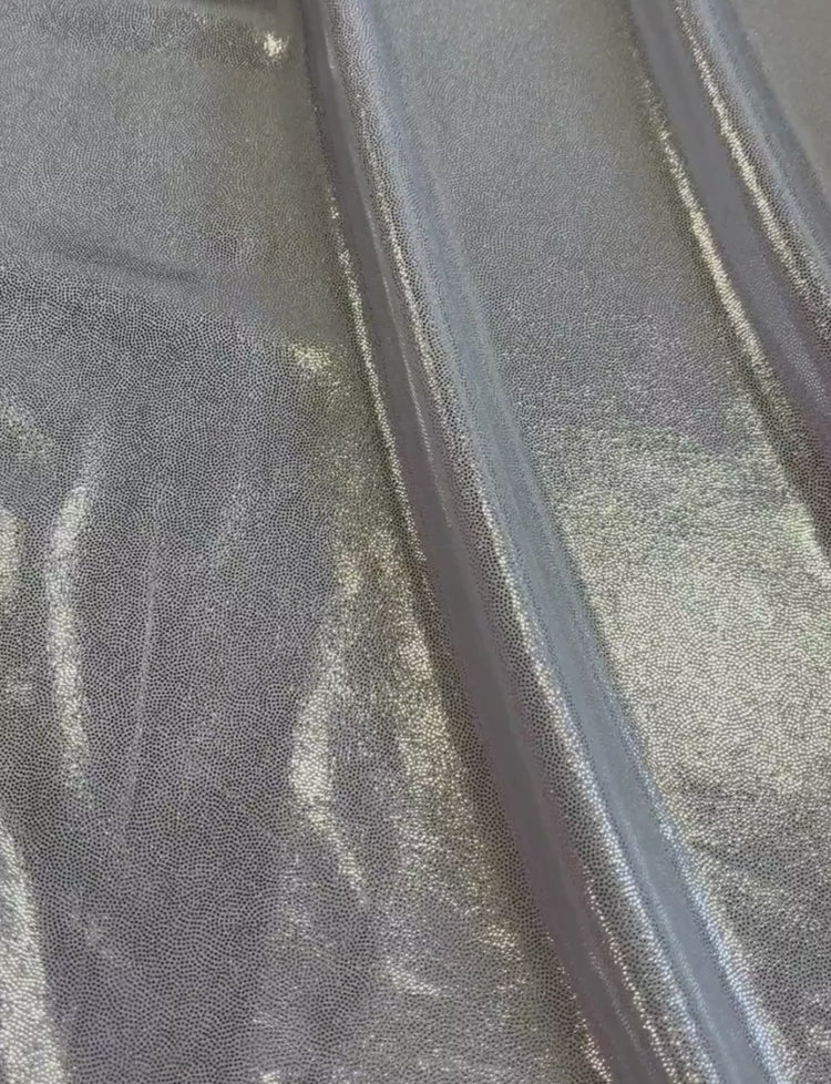 Silver foiled fabric on a white spandex base.