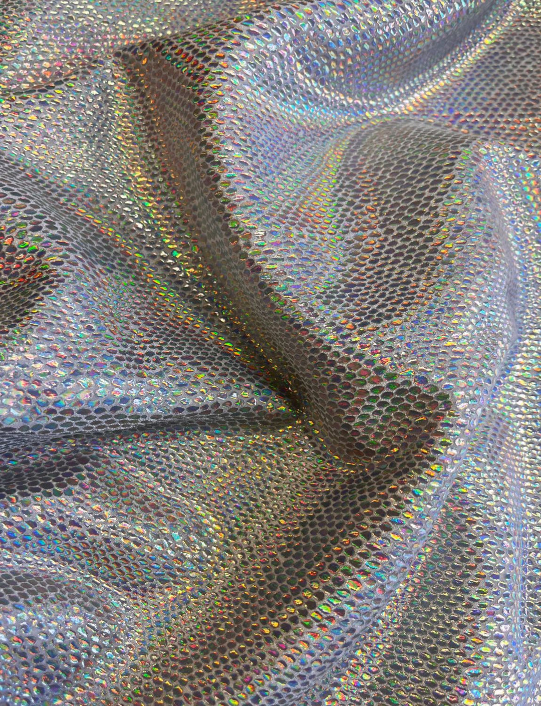 Silver holographic lizard print stretch velvet fabric.